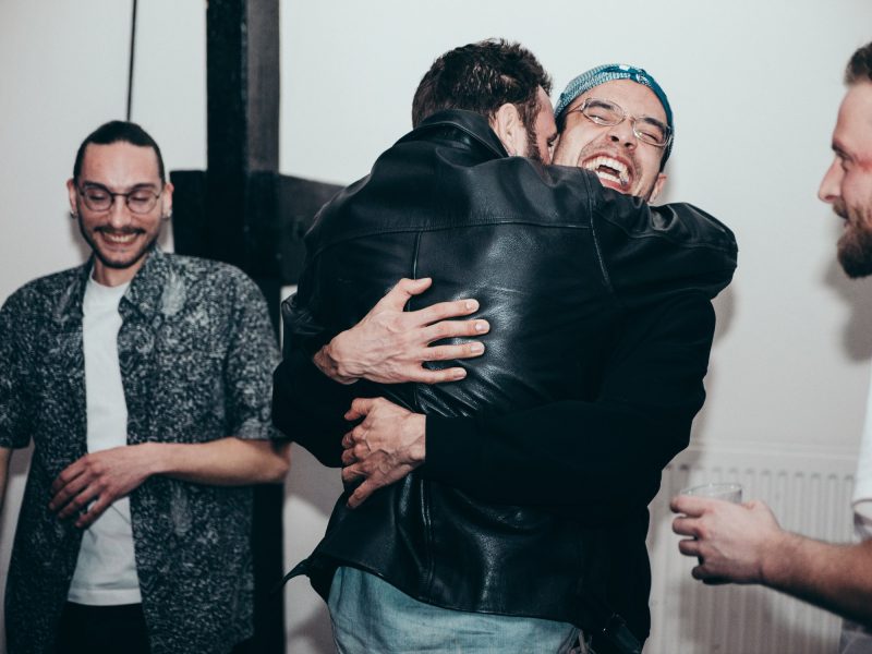 Friends hugging and laughing