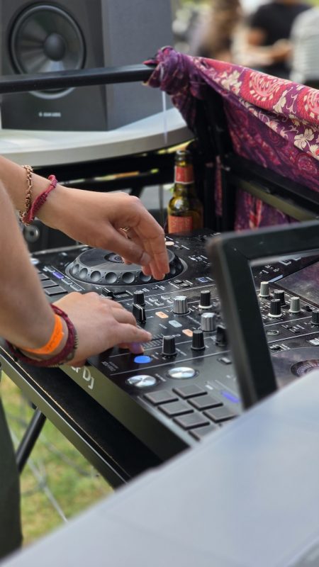 The DJ's hands on the mixer