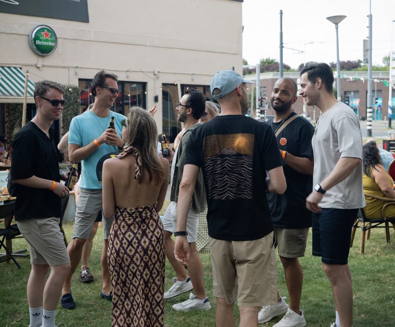 Guests standing and talking on the grass