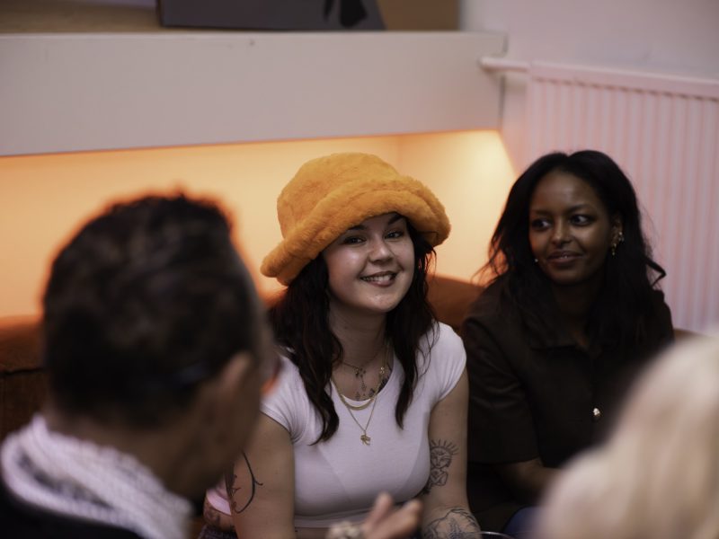Guests laughing together on the sofa